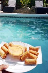 a plate of food next to a swimming pool at Beach house with nice private pool ,baie orientale in Orient Bay