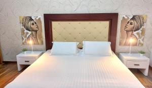 a bedroom with a large bed with two night stands at Spacious family-friendly apartment in the heart of Bllok in Tirana +14 photos