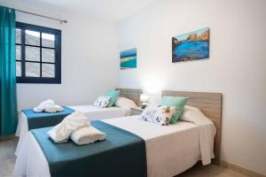 une chambre avec deux lits et une fenêtre dans l'établissement El Rincón del Mar, à Lajita