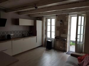 a living room with a kitchen and a large window at ilederesibois in Les Portes