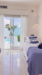 a bedroom with a bed and a view of the ocean at Villa Tiguaro Piscina Climat Jacuzzy AC Villa 9 12 in Corralejo
