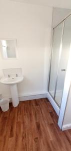 a bathroom with a sink and a shower at Beach Court Holiday Apartments in Skegness