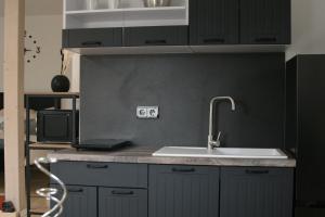 a kitchen with a sink and a counter top at The Manhattan A Boutique Hotel By American Ease in Grafenwöhr