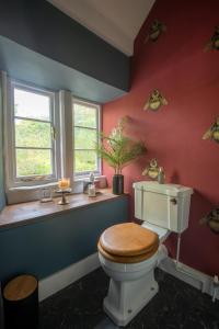 a bathroom with a toilet and a window at Dream Stays Bath - Southbank, EVC Parking in Bath