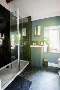 a bathroom with a shower and a tub and a sink at Dream Stays Bath - Southbank, EVC Parking in Bath