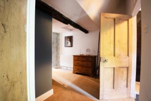 an open door in a room with a dresser at Dream Stays Bath - Southbank, EVC Parking in Bath