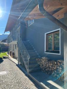 a blue house with stairs and a window at Amelie Ferienwohnung in Garmisch-Partenkirchen