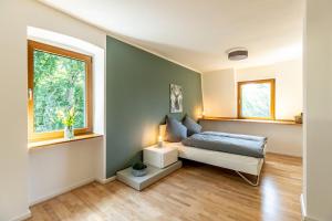 1 dormitorio con cama y ventana en Landhaus Karbach komplett oder einzelne Wohneinheiten Villa inkl Sauna bzw Waldhäuschen en Hirten