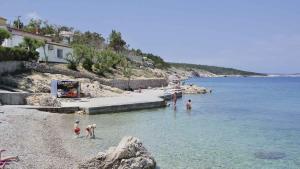 a group of people playing in the water on a beach at Apartments in Silo - Insel Krk 27653 in Šilo