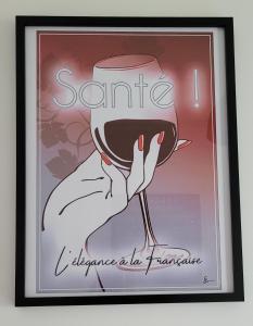 a picture of a person holding a glass of wine at Studio Cosy in Nazelles