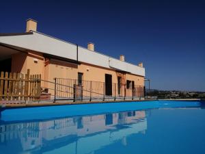 a building with a swimming pool in front of it at La Sperella Bed and Breakfast in Fermo