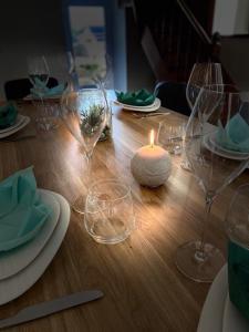 a table with wine glasses and a candle on it at CHEZ ROZ in Rostrenen