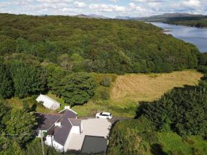 an aerial view of a house with a car on a field at John the mills cottage spaHot tub private beach in Donegal