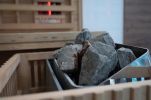 a bin full of rocks in a wooden crate at Hotel Pilot in Cazin