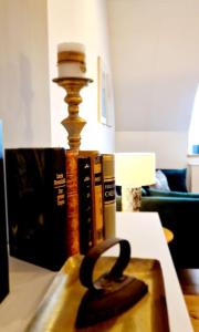 a table with a lamp and books on it at Stilvolle Maisonette Wohnung in Karlsruhe