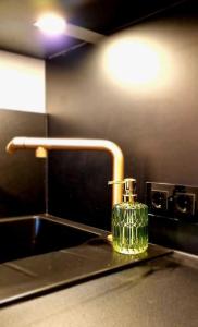 a glass bottle sitting on a counter next to a sink at Stilvolle Maisonette Wohnung in Karlsruhe