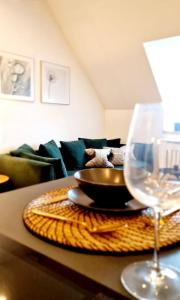 a table with a bowl and a wine glass on it at Stilvolle Maisonette Wohnung in Karlsruhe
