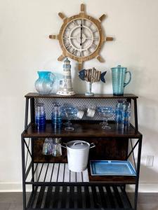 a shelf with glasses and a clock on a wall at Fabulous Family Rancher ! Ocean City NJ Beaches in Somers Point