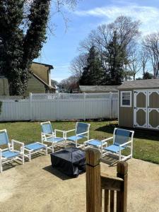 a group of chairs in a yard with a fence at Fabulous Family Rancher ! Ocean City NJ Beaches in Somers Point