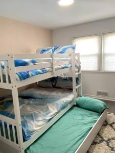 a bedroom with two bunk beds in a room at Fabulous Family Rancher ! Ocean City NJ Beaches in Somers Point