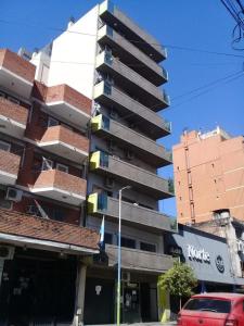 a tall building with a car parked in front of it at Chacabuco 284 in San Miguel de Tucumán