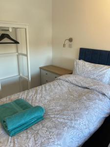 a bed with two towels on top of it at Jolly Sailors Retreat in Wells next the Sea