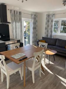 a living room with a wooden table and chairs at Jolly Sailors Retreat in Wells next the Sea
