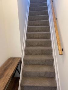 a staircase in a house with a carpeted stair case at Jolly Sailors Retreat in Wells next the Sea
