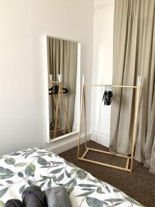a bedroom with a bed and a mirror at Seaview Richmond Terrace in Swansea