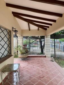a large patio with a table and a bench at casa de marta a 50 mts del centro in Villa Carlos Paz