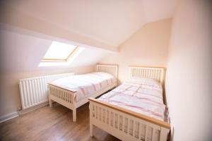 a bedroom with two beds in a attic at Beautiful Sea View, Whitburn, South Tyneside 