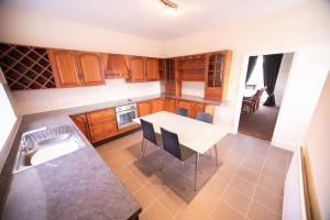 a kitchen with a table and chairs and a sink at Beautiful Sea View, Whitburn, South Tyneside 