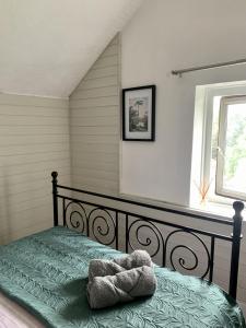 a bedroom with a bed with a stuffed animal on it at Uplands & Channel View, Richmond Tce, Uplands in Swansea