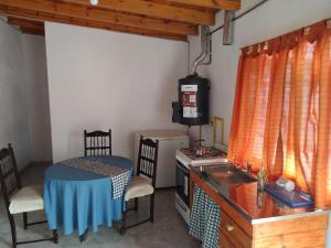 a kitchen with a table and a table and a stove at Depto Guemes in San Luis