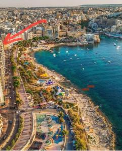 an aerial view of a beach with boats in the water at Sliema 2BR & Parking, Beach Promenade Walks in Sliema