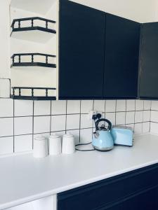 a kitchen counter with a tea kettle and cups at F1 16 Glanmor Cres in Swansea