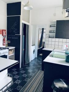 a kitchen with blue and white counters and a sink at F1 16 Glanmor Cres in Swansea