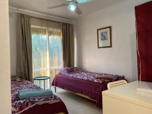 Postel nebo postele na pokoji v ubytování ADA Homestay