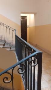 a staircase with a black door in a room at Casa Volsci, 2 camere 2 bagni, Roma centro in Rome