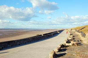 a bridge over a beach next to a beach at Cavendish Cat and Gaming House in Blackpool