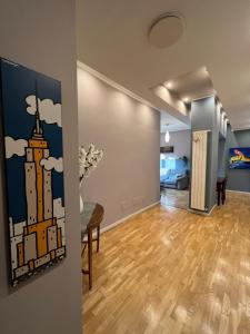 an empty living room with a painting of a building at Premium high floor design apartment in Città Studi in Milan