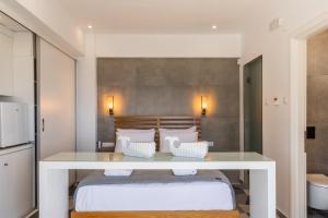 a bedroom with a bed with a white table at Lobster in Leptokaria +44 photos