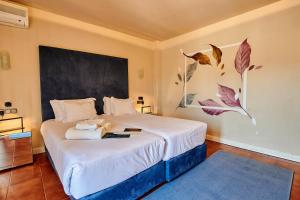 a bedroom with a large bed with a large painting on the wall at Hotel Ronda Valley in Ronda