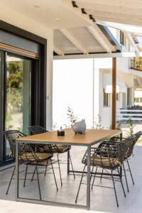 a wooden table and chairs on a patio at Lobster in Leptokaria