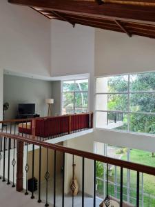 a room with white walls and windows and a staircase at Siri Tropical Retreat in Hikkaduwa