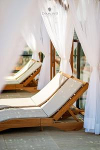 a row of lounges in a store with white curtains at Diamond Hotéis e Flats in São Lourenço