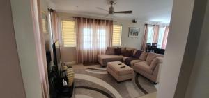 a living room with a couch and a table at Infinity Townhomes at Bagatelle in Saint James