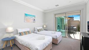 Dos camas en una habitación con balcón. en Unit 48 - 3 Bed Ocean View, en Terrigal 3 fotos más