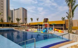 a swimming pool with a slide and a playground at Enjoy Solar das Aguas Park Resort in Olímpia