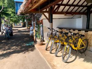 una fila de bicicletas estacionadas al lado de un edificio en Nelly homestay, en Gili Air
